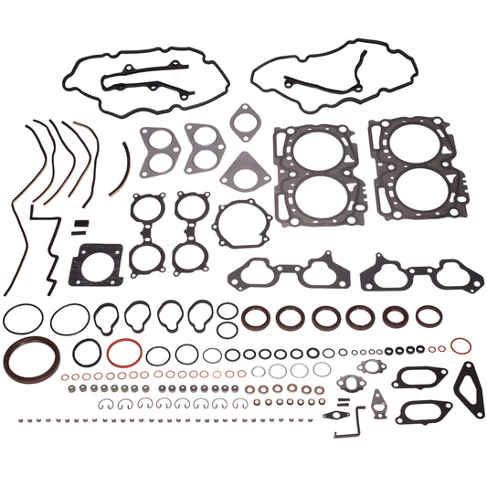 A comprehensive engine gasket and seal kit laid out in a grid pattern on a clean white background. The kit includes various black and dark gray gaskets, seals, O-rings, washers, clips, and fasteners of different shapes and sizes.
